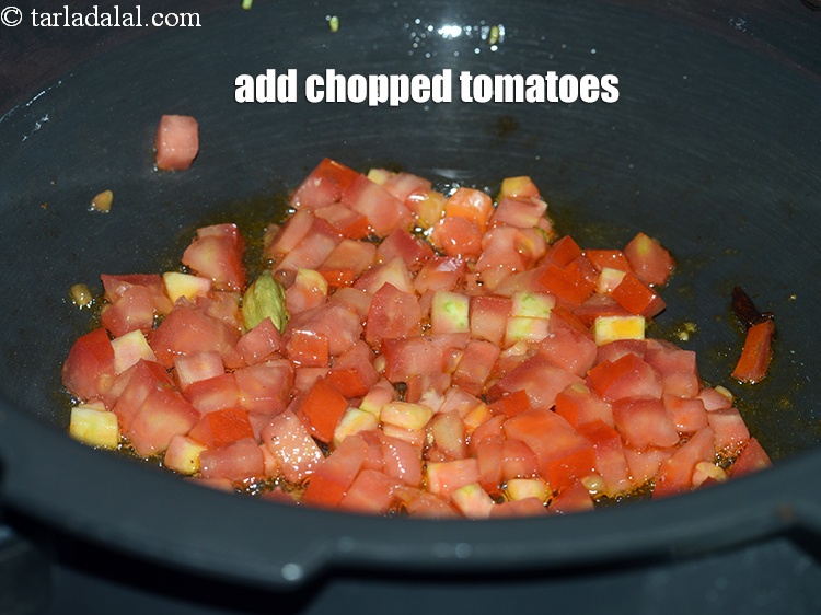 Step 24 – Add &frac12; cup <a href="https://www.tarladalal.com/glossary-chopped-tomatoes-779i">chopped tomatoes</a>.