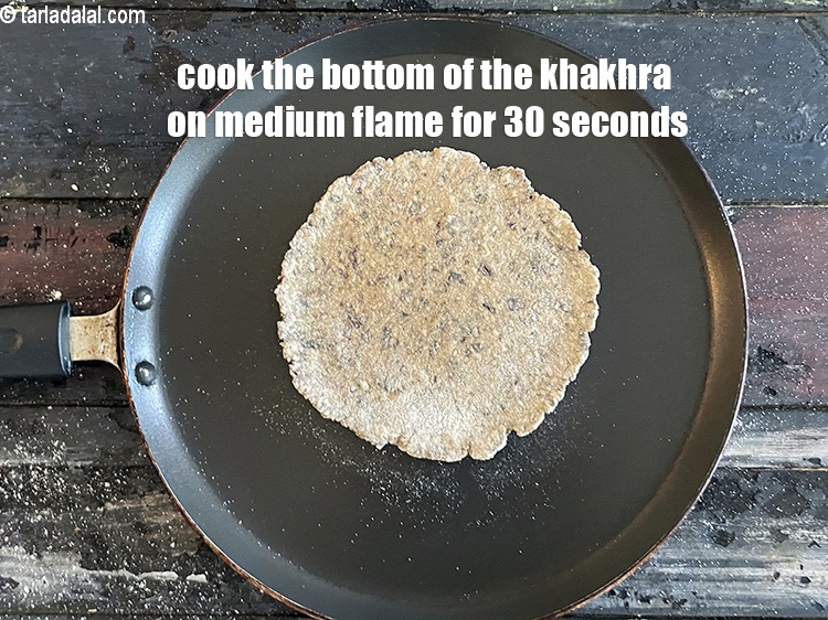 Step 24 – <meta charset="UTF-8" /> Cook the bottom of the khakhra on <strong>medium flame </strong>for 30 seconds …