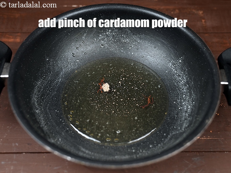Step 24 – Add a pinch of <a href="https://www.tarladalal.com/glossary-cardamom-powder-elaichi-powder-265i">cardamom (elaichi) powder</a>.