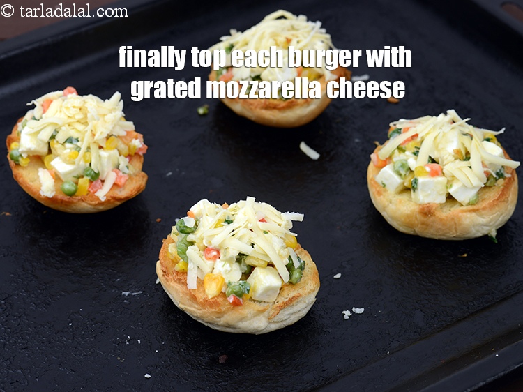 Step 22 – Finally top each burger with 1/2 tbsp&nbsp;<a href="https://tarladalal.com/glossary-grated-mozzarella-cheese-1022i">grated mozzarella cheese</a>.&nbsp;