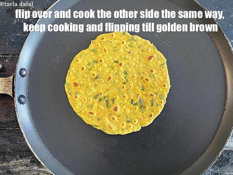 Step 23 – <meta charset="UTF-8" />Flip over and cook the other side of the&nbsp;paratha the same way.