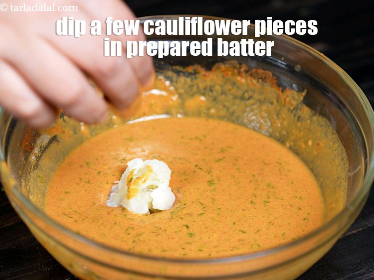 Step 22 – Dip a few cauliflower pieces in the prepared batter.&nbsp;&nbsp;