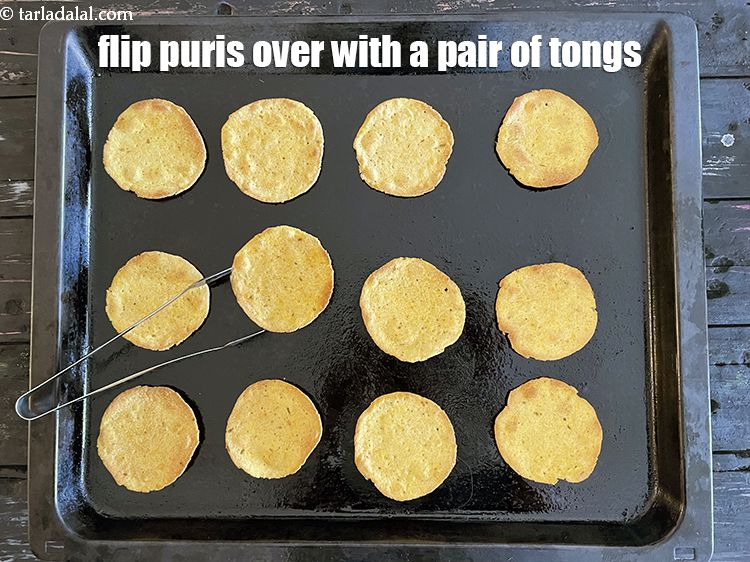 Step 24 – Flip puris over with a pair of tongs.