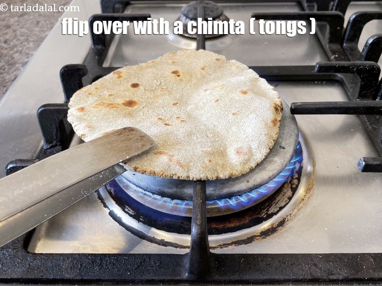 Step 26 – Flip over with a chimta or pair of tongs.