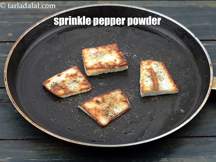 Step 24 – Sprinkle pepper powder evenly over the paneer slices.