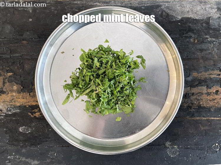 Step 28 – In a plate put&nbsp;<meta charset="UTF-8" />1/4 cup&nbsp;finely&nbsp;<a href="glossary-chopped-mint-788i">chopped mint leaves (phudina)</a>.