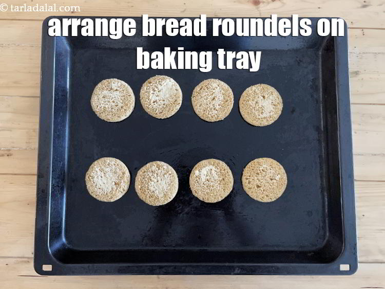 Step 22 – Arrange bread roundels on a baking tray with the buttered side facing upwards.
