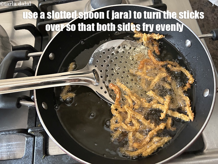 Step 24 – Use a slotted spoon to turn the sticks over so that they fry evenly on …