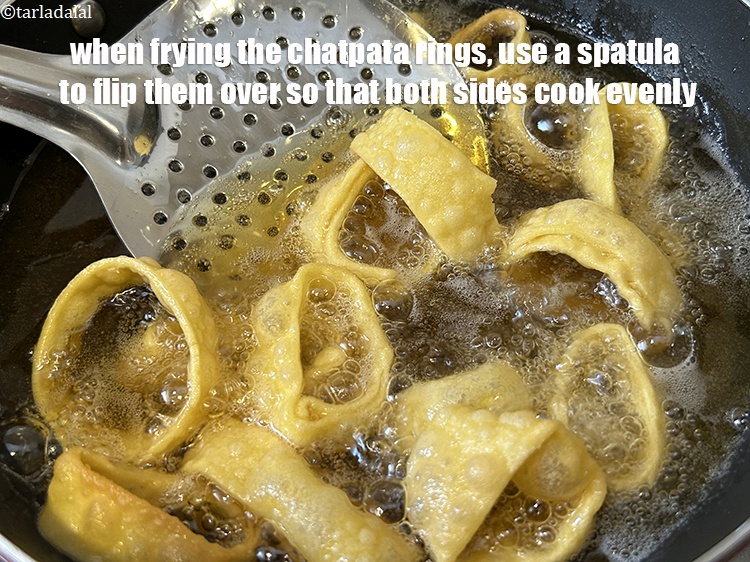 Step 33 – When frying the chatpata rings, use a spatula to flip them over so that both …