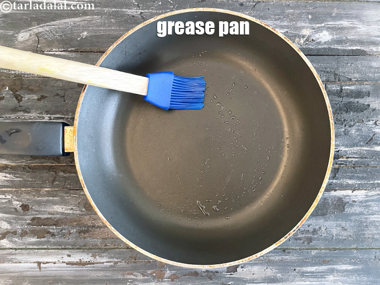 Step 29 – <meta charset="UTF-8" /> Heat a non-stick pan and grease it with &frac12; tsp of oil.