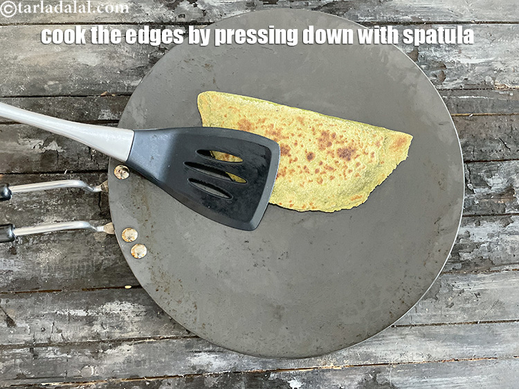Step 50 – Remember to press down on the edges of the paratha with the spatula to ensure …