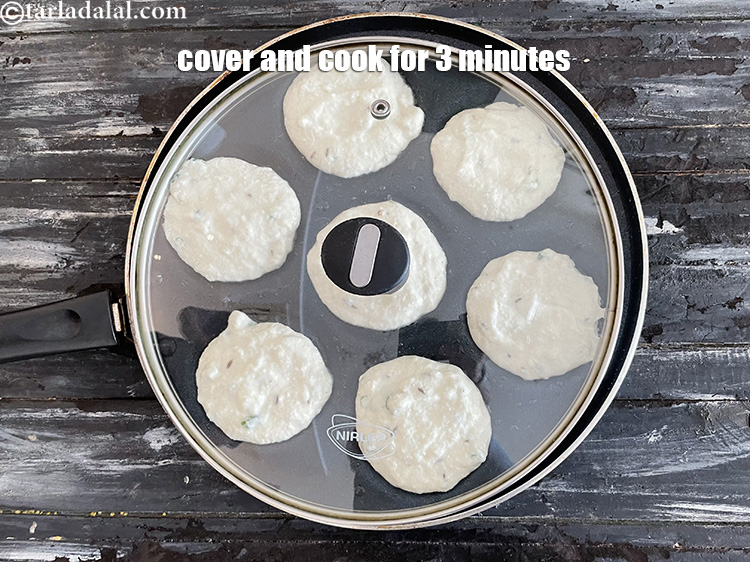 Step 19 – Cover and cook the sooji uttapam on medium flame for 3 minutes.
