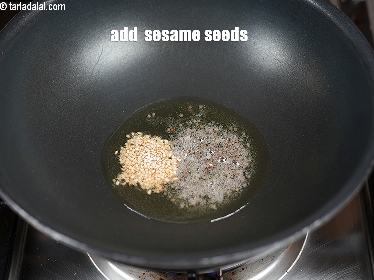 Step 24 – Add &frac12; tsp <a href="https://www.tarladalal.com/glossary-sesame-seeds-til-gingelly-seeds-612i">sesame seeds (til)</a>.