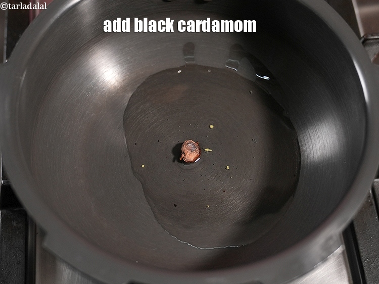 Step 24 – Add 1&nbsp;<a href="https://www.tarladalal.com/glossary-black-cardamom-badi-elaichi-moti-elaichi-263i">black cardamom (badi elaichi)</a>.