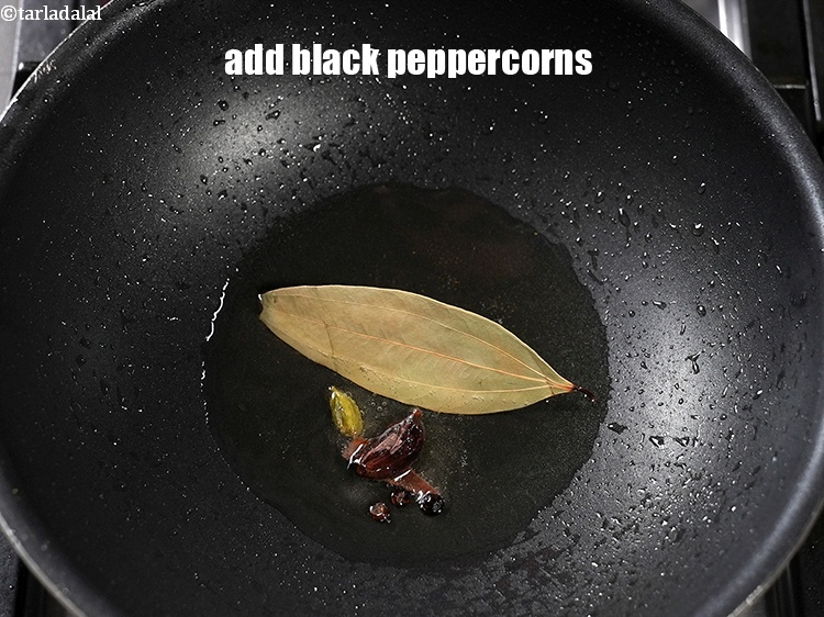 Step 24 – Add 3 <a href="https://www.tarladalal.com/glossary-black-peppercorns-kali-mirch-kalimirch-566i">black peppercorns (kalimirch)</a>.