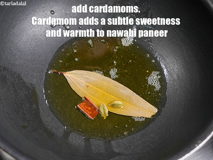 Step 24 – Add 2 <a href="https://www.tarladalal.com/glossary-cardamom-elaichi-262i">cardamoms (elaichi)</a>. Cardamom adds a subtle sweetness and warmth to nawabi paneer.