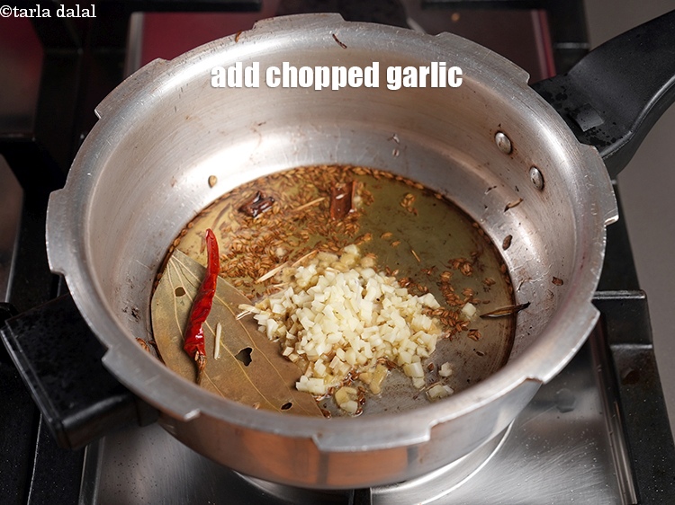 Step 24 – Add 1 tbsp <a href="https://www.tarladalal.com/glossary-chopped-garlic-790i">chopped garlic (lehsun)</a>.
