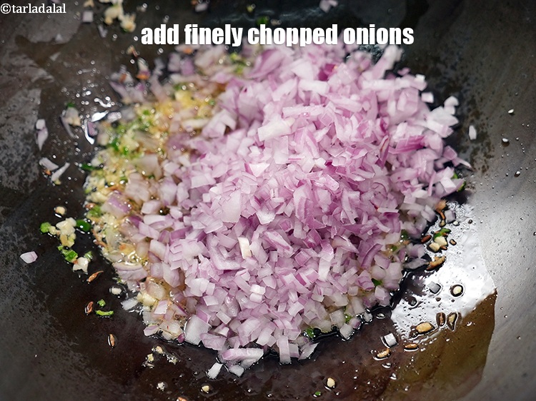 Step 25 – <p>Add 1 cup finely <a href="https://www.tarladalal.com/glossary-chopped-onions-722i">chopped onions</a>.</p>