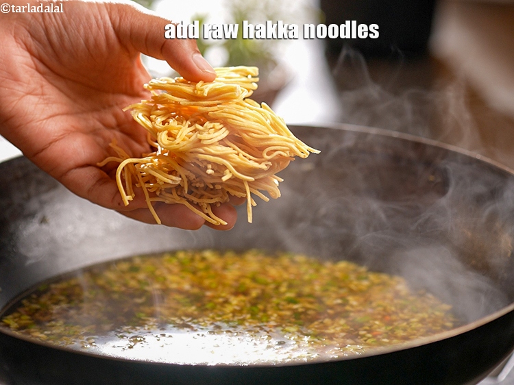 Step 24 – Then add 1 cup raw <a href="https://www.tarladalal.com/glossary-hakka-noodles-1413i">hakka noodles</a>.