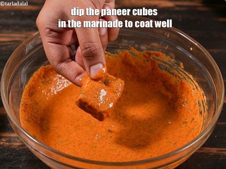 Step 24 – Dip the paneer cubes in the marinade to coat well.