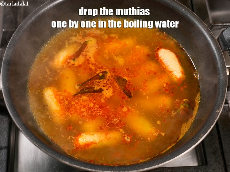 Step 24 – Drop the muthias one by one in the boiling water.