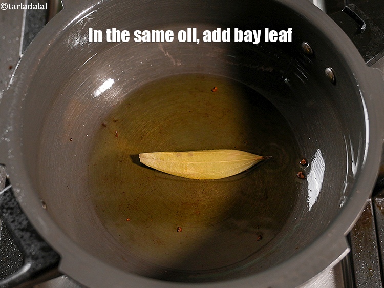 Step 24 – In the same oil, add 1 <a href="https://www.tarladalal.com/glossary-bay-leaf-tejpatta-bay-leaves-189i">bay leaf (tejpatta)</a>.&nbsp;