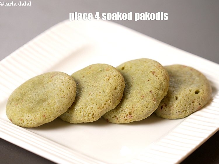 Step 24 – Place 4 soaked pakodis on a serving plate.