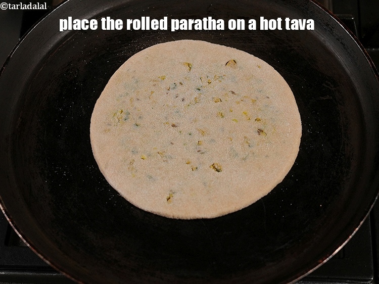 Step 36 – Place the rolled paratha on a hot tava.