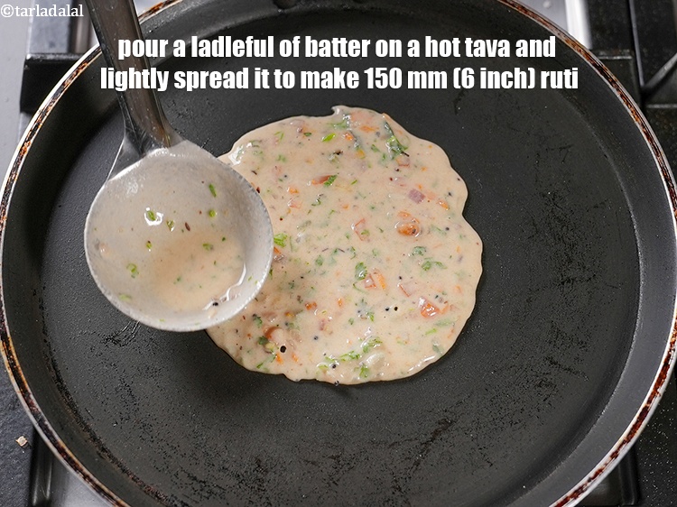 Step 24 – Pour a ladleful of batter on a hot tava and lightly spread it to make …