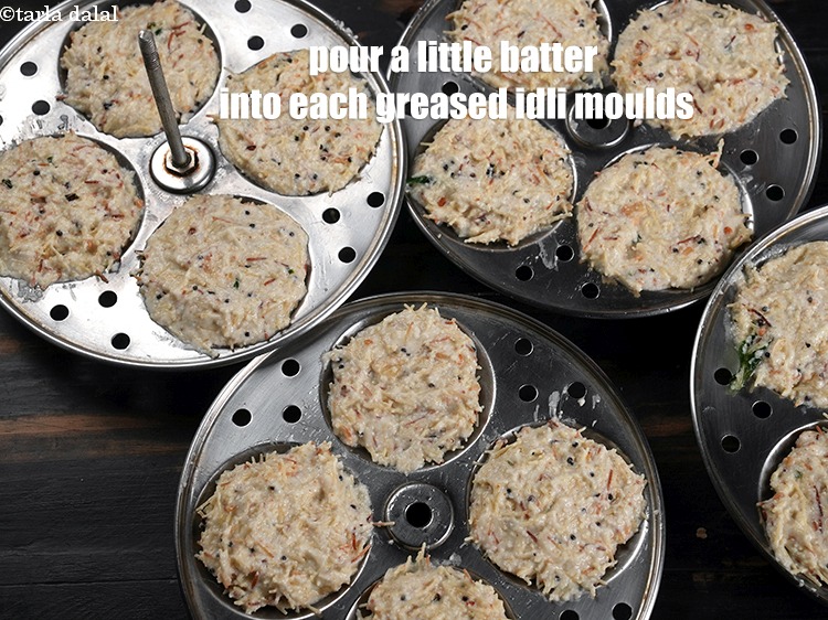 Step 29 – Pour a little batter into each of the greased idli moulds.&nbsp;