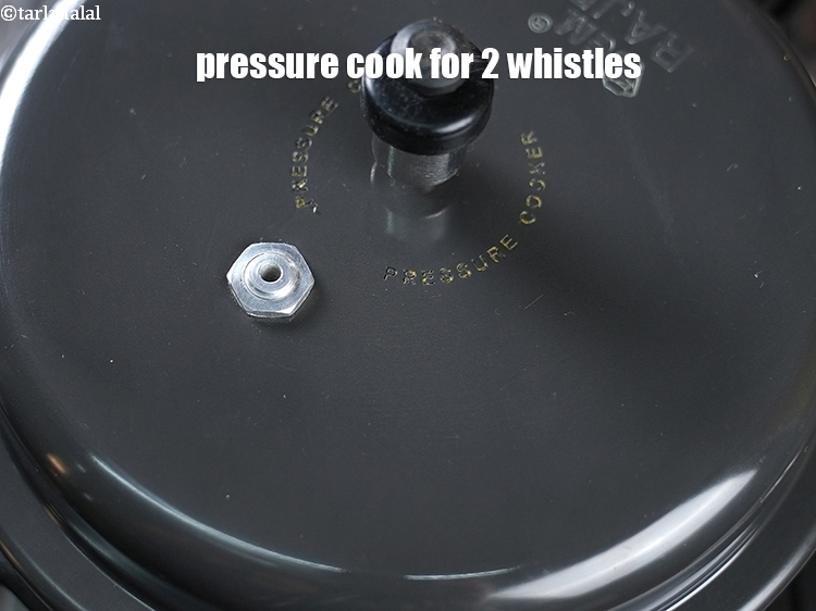 Step 24 – Cover with a lid and pressure cook for 2 whistles on medium flame.