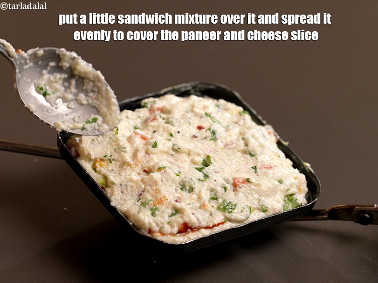 Step 24 – Put a little sandwich mixture over it and spread it evenly to cover the paneer …