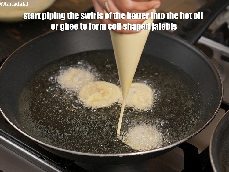 Step 24 – Start piping the swirls of the batter into the hot oil or ghee to form …