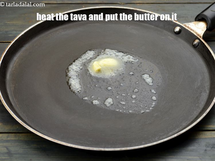 Step 29 – Take a tava and heat it till it is hot enough. Put 3 tsp&nbsp;<a href="https://www.tarladalal.com/glossary-butter-makhan-233i">butter</a> …