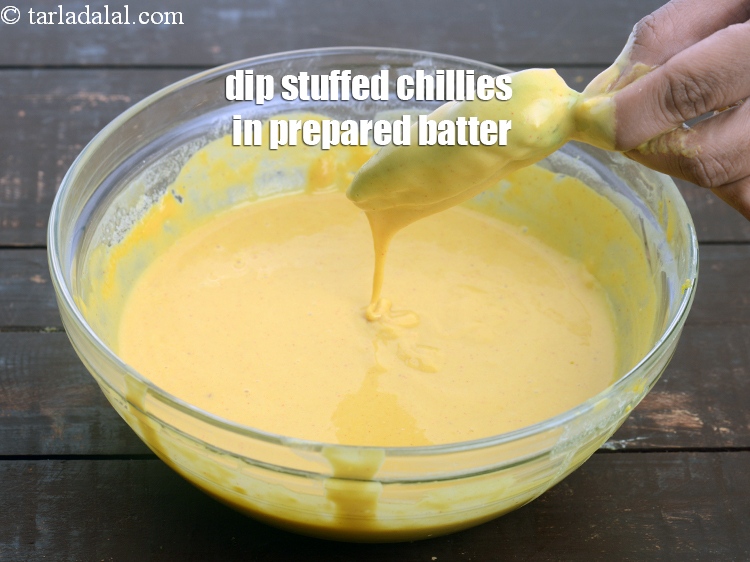Step 26 – Dip the stuffed chillies in the prepared batter.