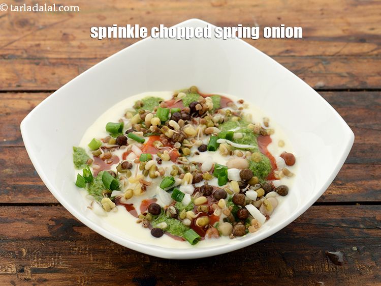 Step 56 – Sprinkle 1 tbsp <a href="https://www.tarladalal.com/glossary-spring-onion-hara-pyaz-443i#ing_815" target="_blank">spring onions</a> evenly over it.