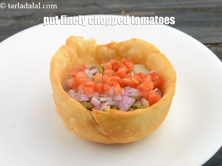 Step 26 – Put &frac12; tbsp finely&nbsp;<a href="https://www.tarladalal.com/glossary-chopped-tomatoes-779i">chopped tomatoes</a>.