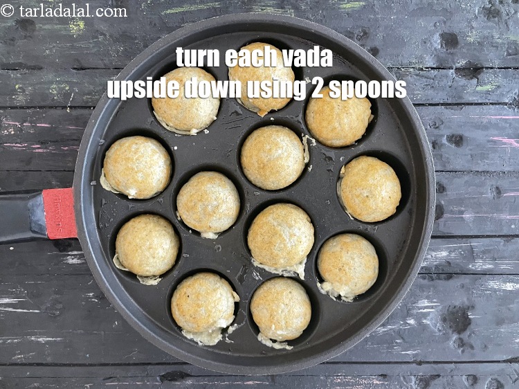 Step 24 – <meta charset="UTF-8" />Turn each vada upside down using a fork or 2 spoons.