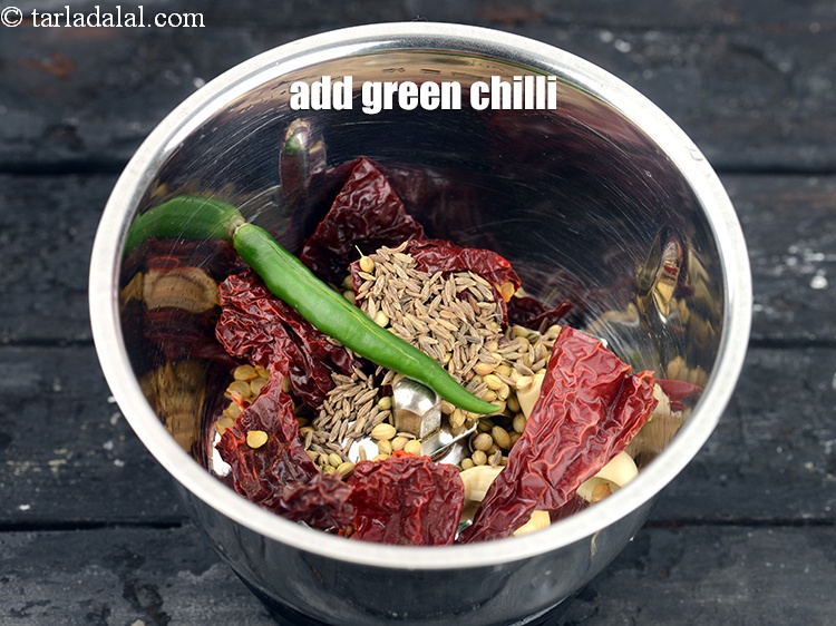 Step 25 – Add 1 <a href="https://www.tarladalal.com/glossary-green-chillies-hari-mirch-331i">green chilli</a>.