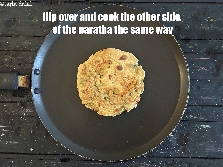 स्टेप 31 – पराठे को पलटिये और दूसरी तरफ भी इसी तरह पका …