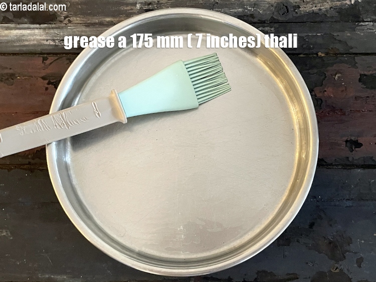 Step 24 – <meta charset="UTF-8" />Grease a 175 mm. (7&rdquo;) diameter thali.