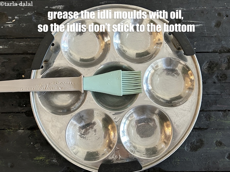 Step 30 – <meta charset="UTF-8" />Meanwhile, grease the idli moulds with oil so that the idlis do not …