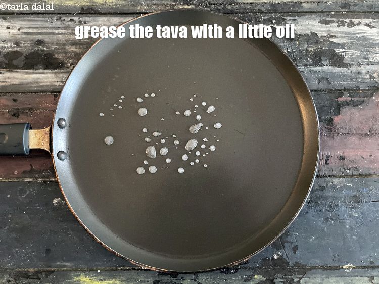 Step 24 – Grease the tava (griddle) with a little oil.