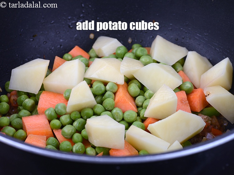 Step 25 – Add &frac12; cup <a href="https://www.tarladalal.com/glossary-potato-cubes-725i">potato cubes</a>.