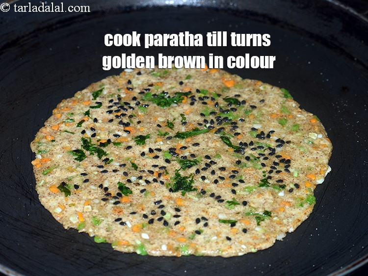 Step 24 – Cook the paratha on medium flame till it turns golden brown in colour from both …