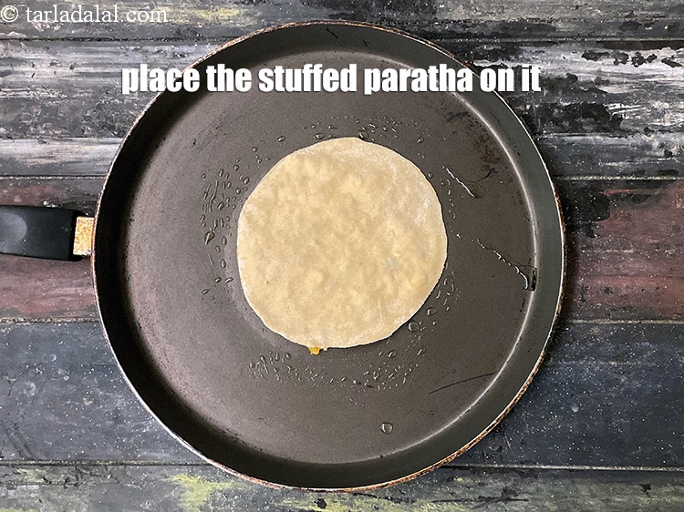 Step 32 – Place the stuffed paratha on it.&nbsp;