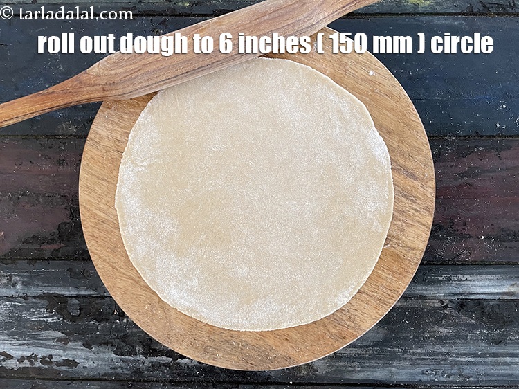 Step 26 – <meta charset="UTF-8" /> Roll dough into a 150 mm. (6&rdquo;) diameter circle using a little …