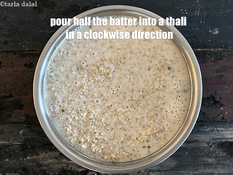 Step 24 – <meta charset="UTF-8" />Pour half the batter into the thali in a clockwise direction.&nbsp;&nbsp;