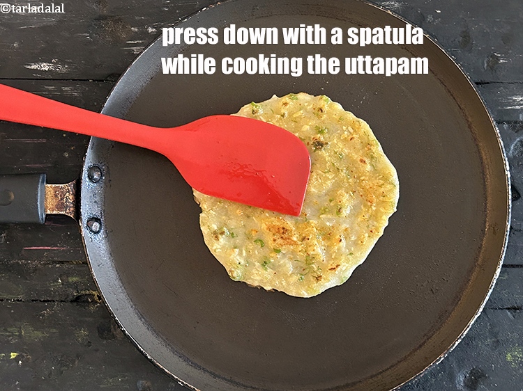 Step 24 – Press down with a spatula while cooking the uttapam.