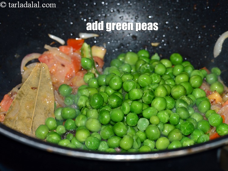 Step 24 – Add 1 cup <a href="https://www.tarladalal.com/glossary-green-peas-matar-hare-matar-vatana-180i">green peas</a>.
